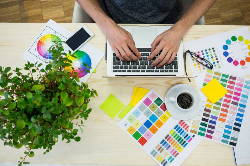 Hands of male graphic designer using laptop